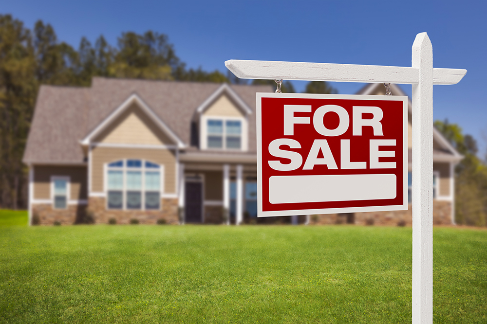 For sale sign in front of a house before home inspection services are provided